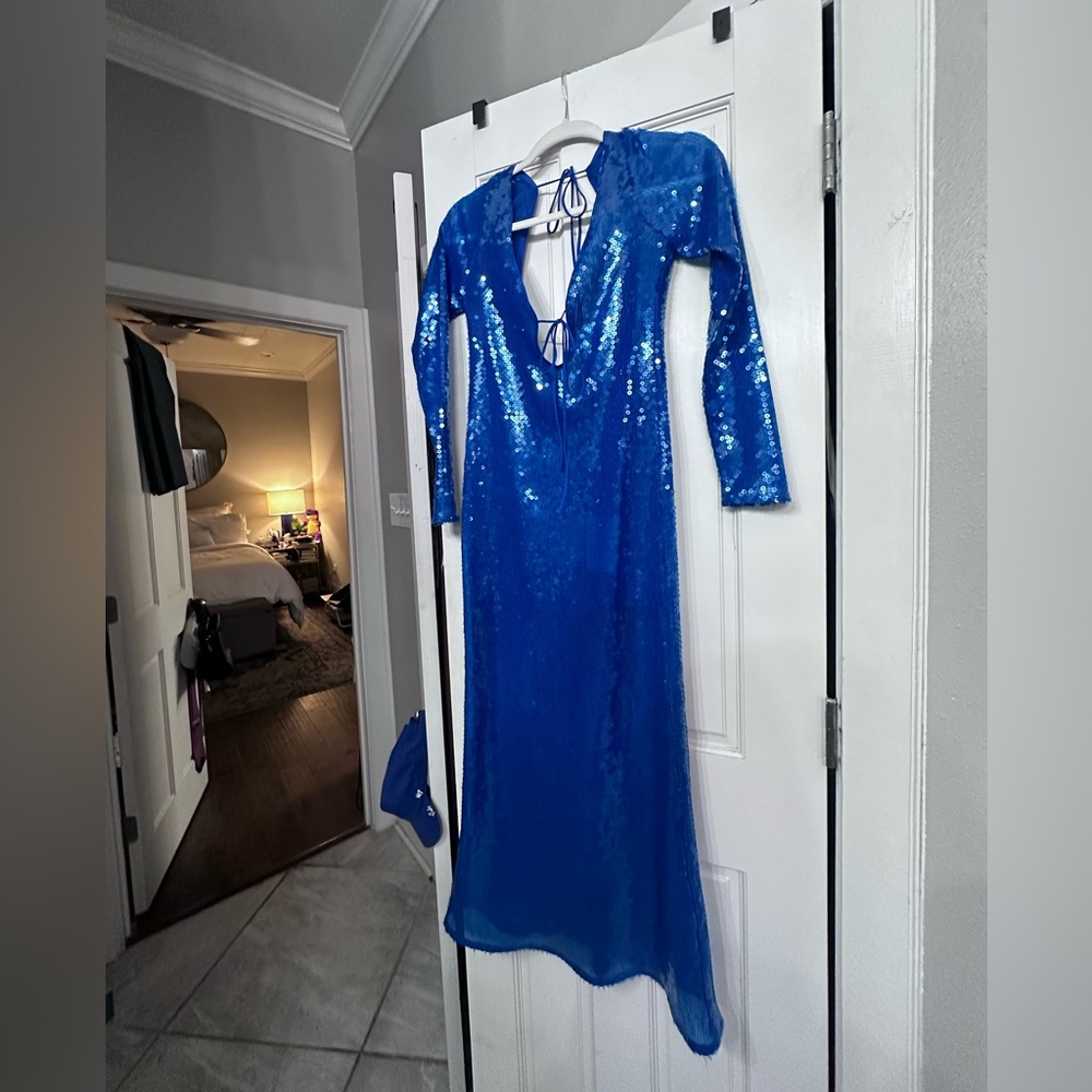 Blue sequin midi dress with open back and deep front plunge.